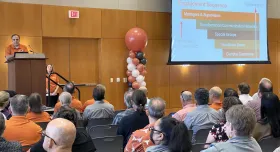 ECS Director, Mark Jacaman stands at podium speaking to UT employees during UT Works launch presentation.